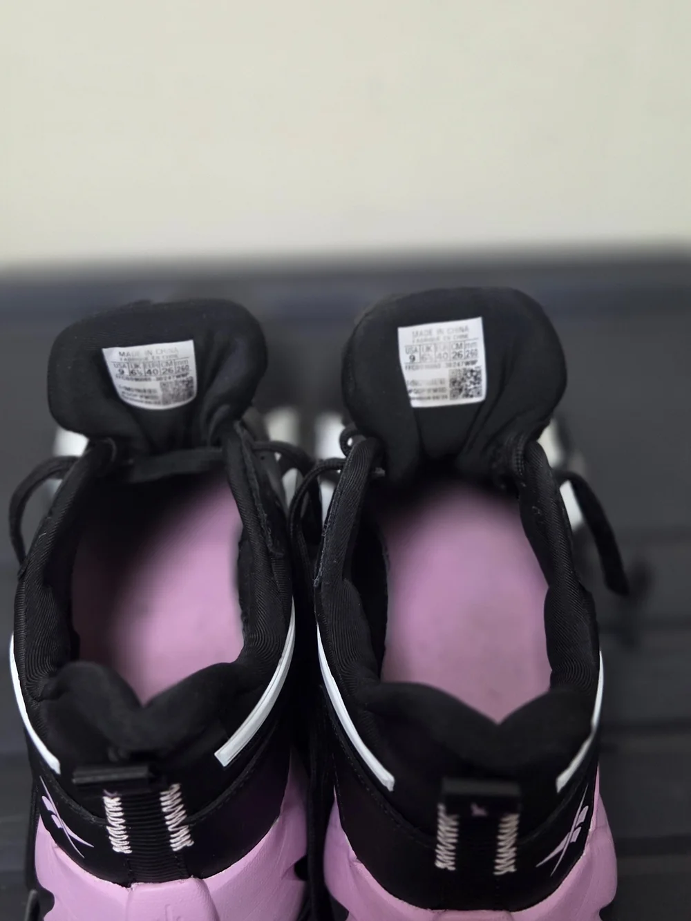 Reebok Black Athletic Sneakers with White Stripes and Pink Logo